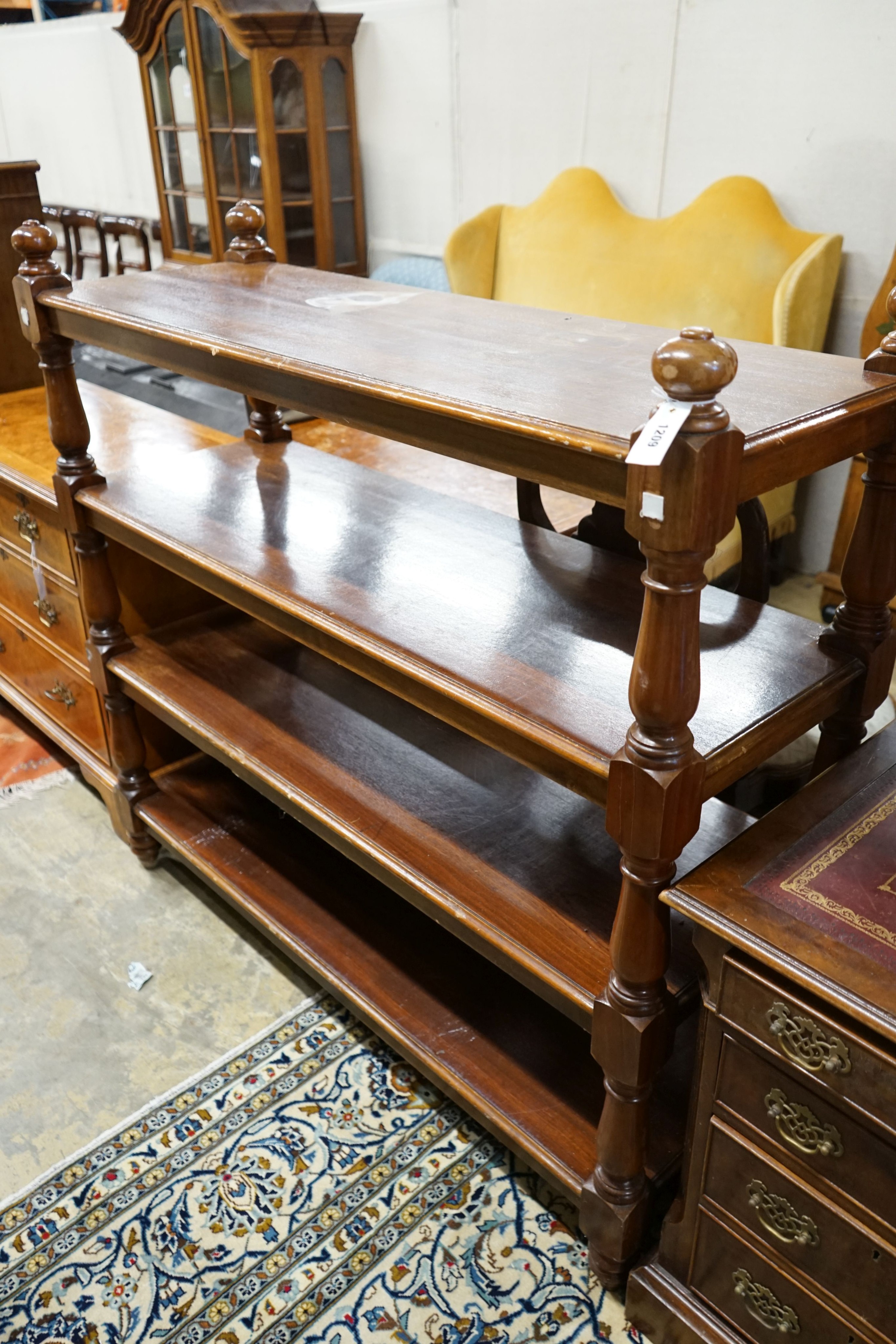 A Victorian style mahogany four tier buffet, length 136cm, depth 48cm, height 130cm